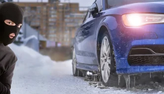 A robber peeking around a corner at a car in the snow